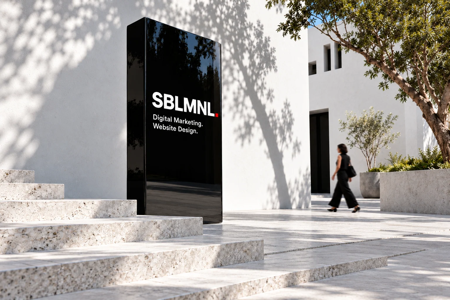 A SBLMNL sign in a bright architectural courtyard.